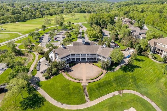 drone / aerial view with a forest view and view of golf course