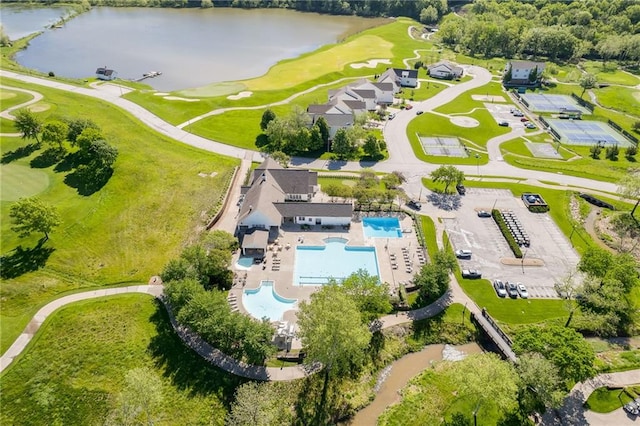 drone / aerial view featuring golf course view and a water view