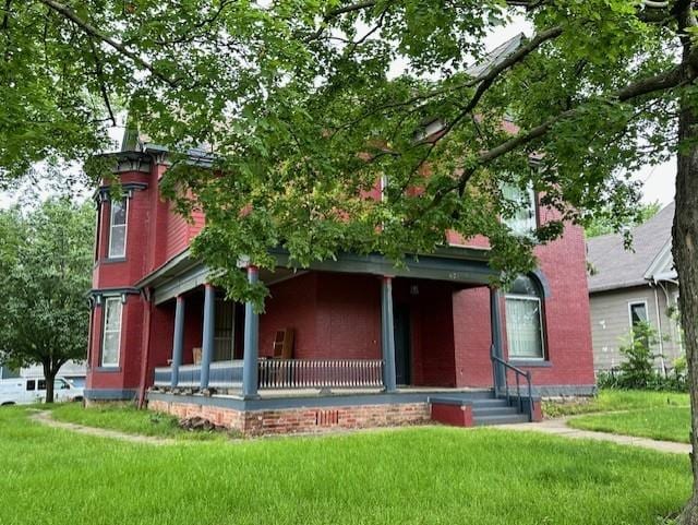 view of front facade featuring a front lawn and covered porch