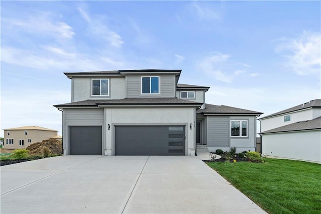 view of front of house featuring a front lawn and a garage