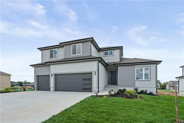 view of front of house with a front lawn and a garage