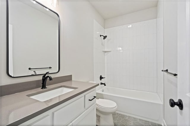 full bathroom with tiled shower / bath, vanity, toilet, and tile patterned floors