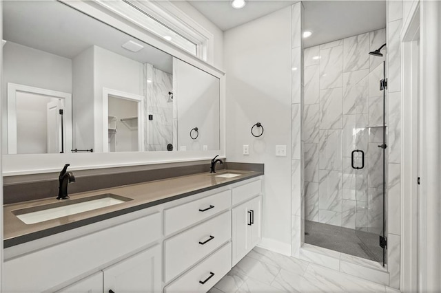 bathroom featuring vanity and a shower with door