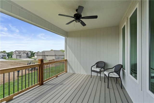 wooden deck featuring a yard and ceiling fan