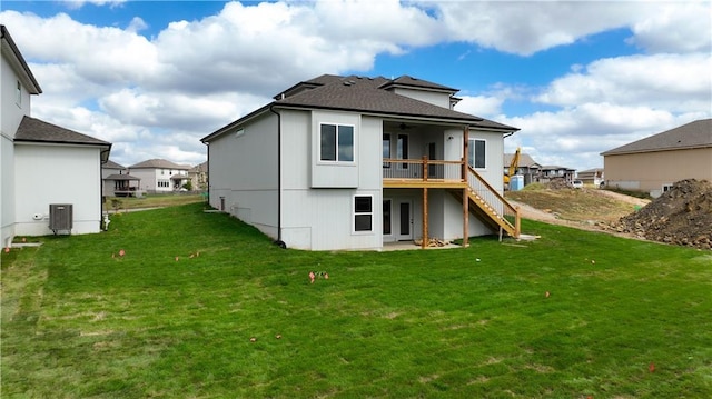 back of property featuring central AC unit and a yard