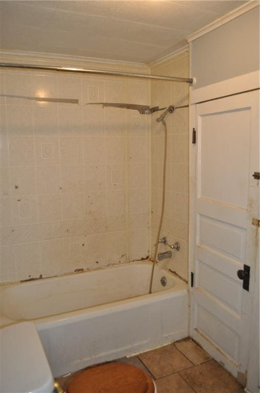 bathroom with tiled shower / bath combo and tile floors