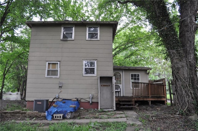 rear view of house with a wooden deck and central AC unit