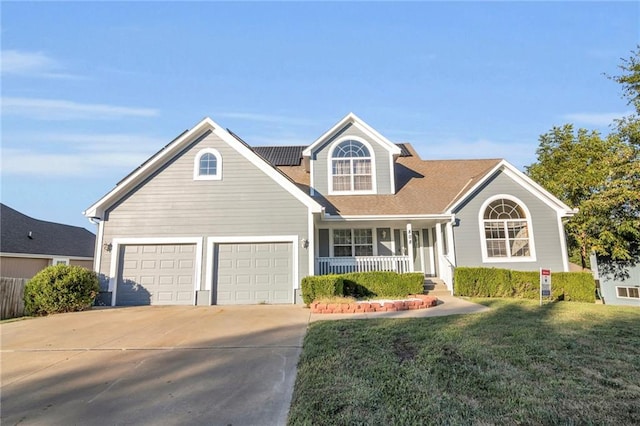 view of front of property with covered porch, a front yard, and a garage