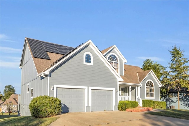 view of front of house with a garage and solar panels