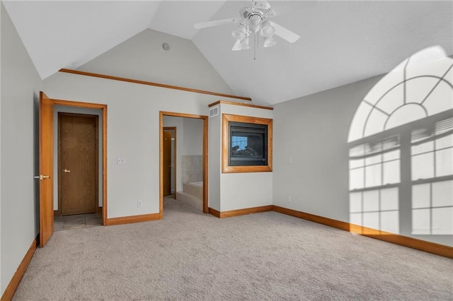 carpeted spare room featuring ceiling fan and lofted ceiling