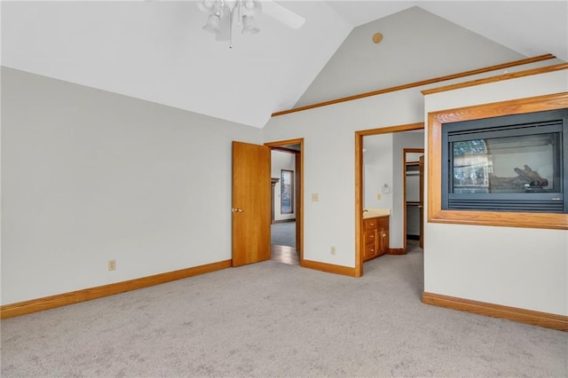 unfurnished bedroom with ceiling fan, light colored carpet, and high vaulted ceiling