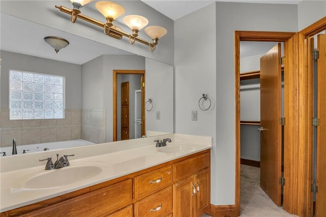 bathroom featuring vanity and a tub to relax in