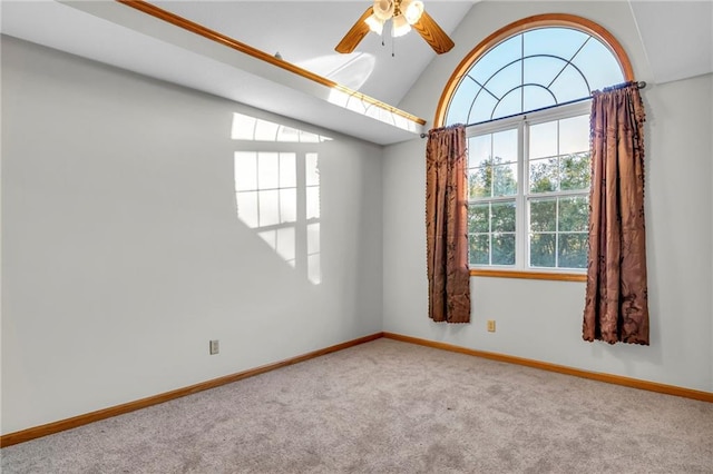 carpeted spare room with vaulted ceiling and ceiling fan