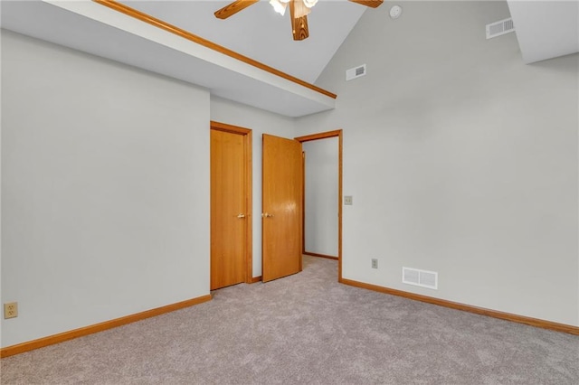 spare room featuring ceiling fan, light colored carpet, and high vaulted ceiling