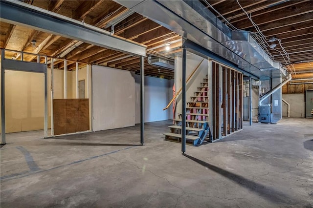 basement featuring heating unit and electric panel