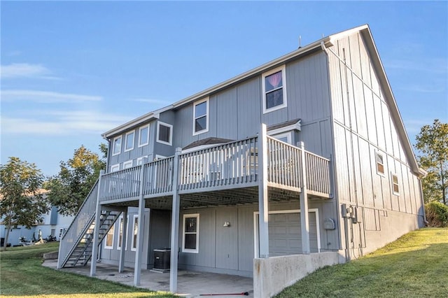 back of house featuring a wooden deck, a garage, a yard, and central AC unit