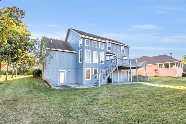 back of house with a wooden deck, a yard, a garage, and central air condition unit