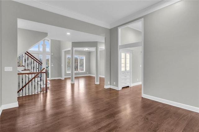 interior space featuring dark hardwood / wood-style floors, ornate columns, plenty of natural light, and crown molding