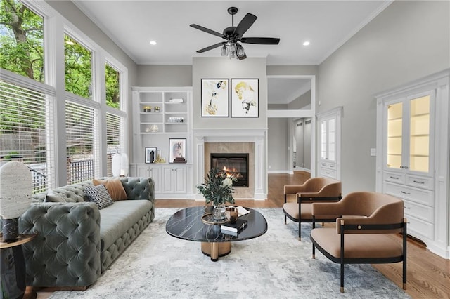 living room featuring ceiling fan, crown molding, and wood-type flooring