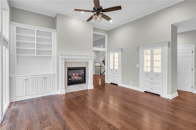 unfurnished living room featuring dark hardwood / wood-style flooring and ceiling fan