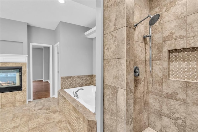 bathroom featuring a fireplace and shower with separate bathtub