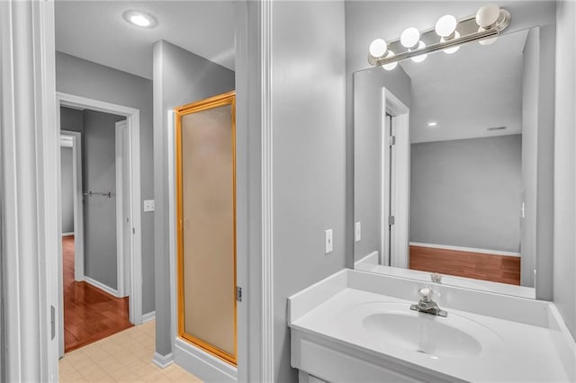 bathroom featuring vanity and a shower with shower door