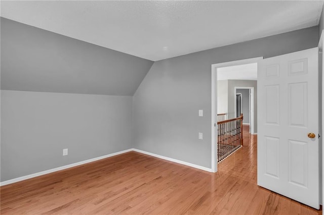 bonus room featuring light hardwood / wood-style floors and vaulted ceiling