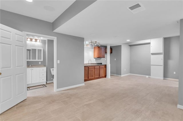 unfurnished living room with sink