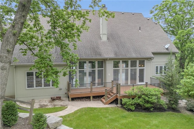 back of house with a lawn and a wooden deck