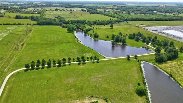 birds eye view of property featuring a water view and a rural view