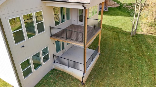 back of house with a patio area and a lawn