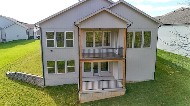 rear view of property featuring a lawn