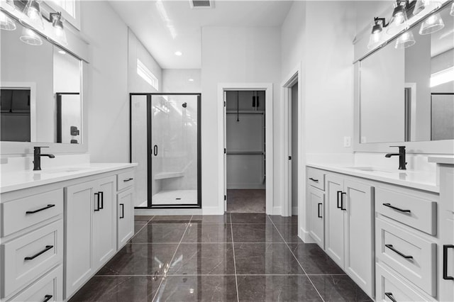 bathroom with vanity and a shower with shower door