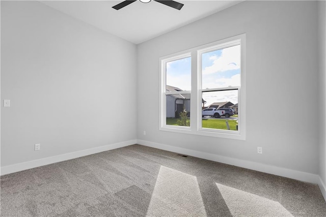 spare room with ceiling fan and carpet floors