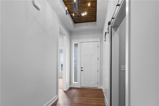 doorway with dark hardwood / wood-style flooring and a barn door