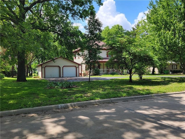 view of front of property featuring a front yard and a garage