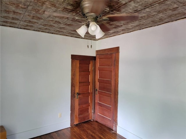 spare room with ceiling fan and dark hardwood / wood-style floors