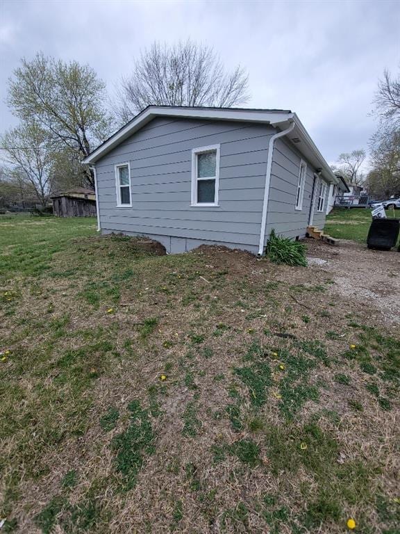 view of side of home featuring a lawn