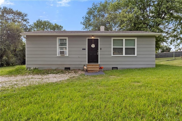 bungalow featuring entry steps, crawl space, fence, and a front lawn