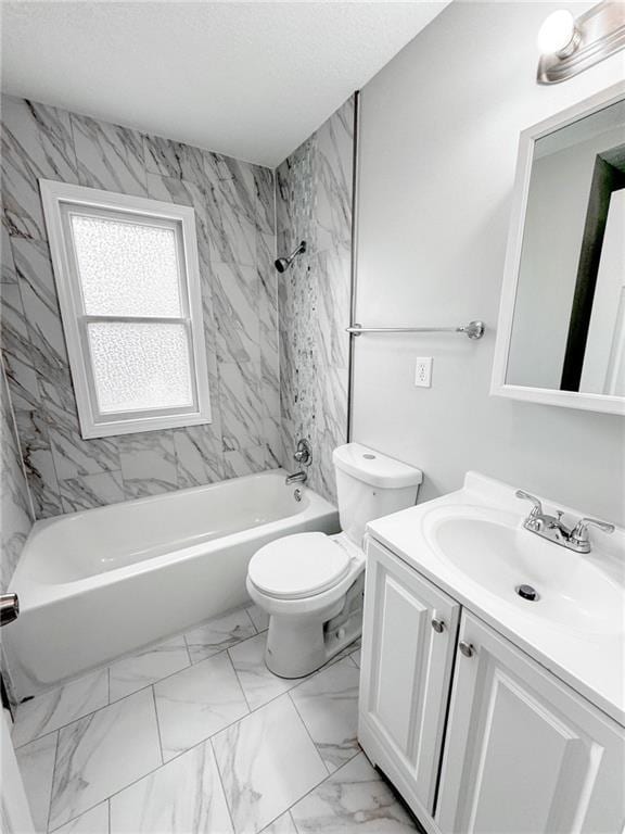 full bath with a textured ceiling, toilet, vanity, marble finish floor, and washtub / shower combination