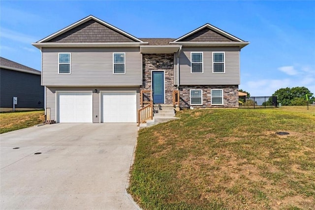 bi-level home featuring a front yard and a garage