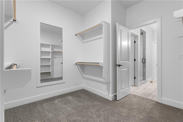 spacious closet with carpet flooring