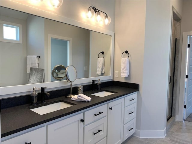 bathroom with vanity and a shower with shower door