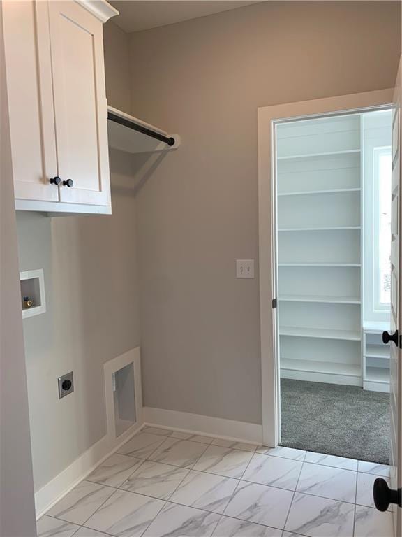 laundry area with cabinets, hookup for a washing machine, and electric dryer hookup