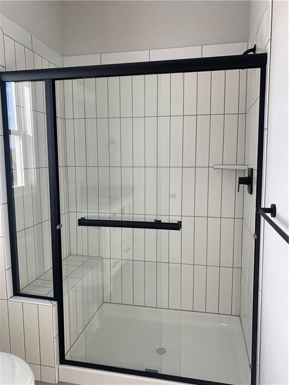 bathroom with toilet and walk in shower