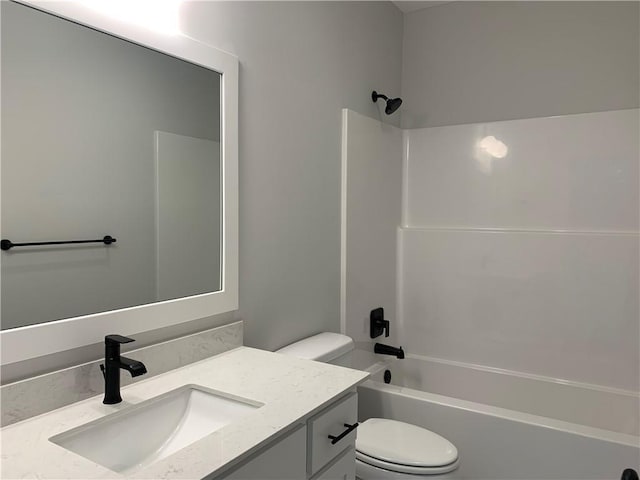 full bathroom featuring vanity, bathing tub / shower combination, and toilet