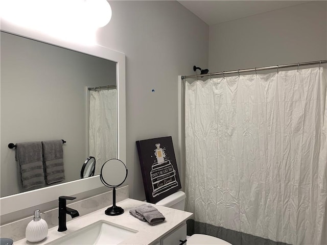 bathroom featuring vanity, curtained shower, and toilet