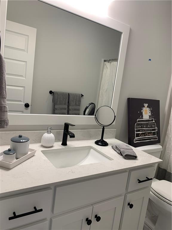 bathroom with vanity and toilet