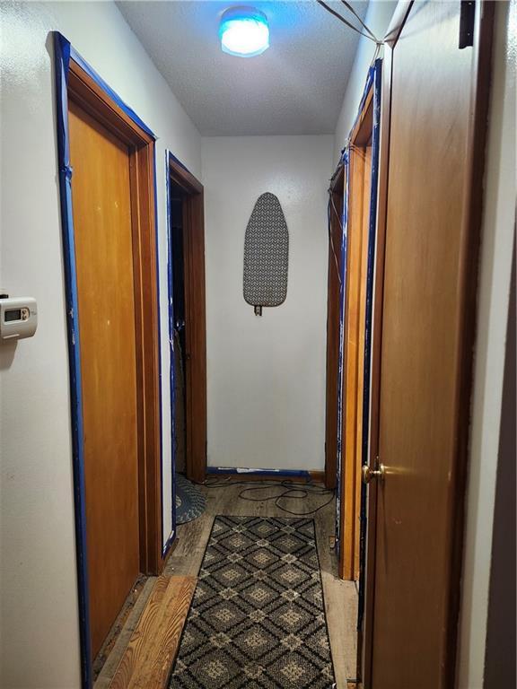 2821 Stark Ave, Kansas City, MO 64129 - hallway featuring wood finished floors