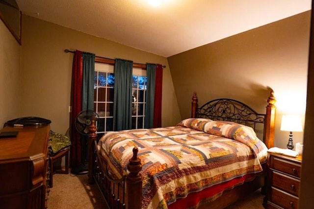 bedroom with lofted ceiling and carpet floors